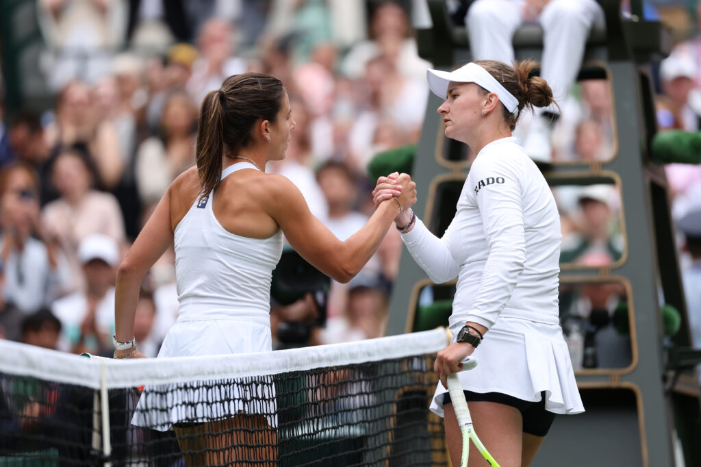 Barbora Krejcikova and Emma Navarro shake hands at the net after their clash at Wimbledon.