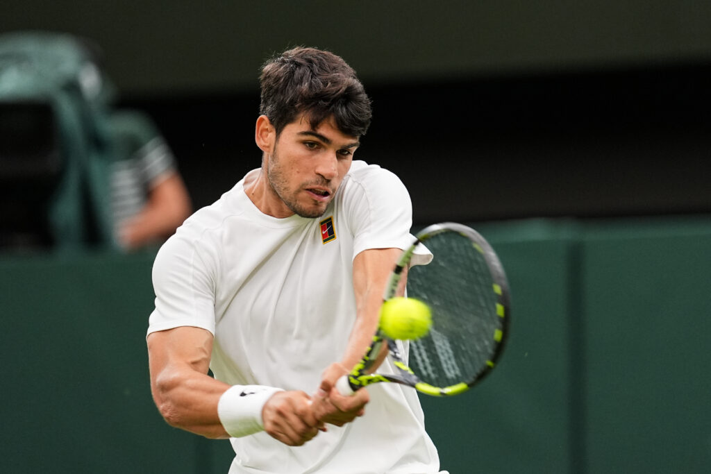 Carlos Alcaraz of Spain plays a backhand in the Gentlemen's Singles Fourth Round match against Andrey Rublev on day seven of The Championships Wimbledon 2025 at All England Lawn Tennis and Croquet Club on July 06, 2025 in London, England.