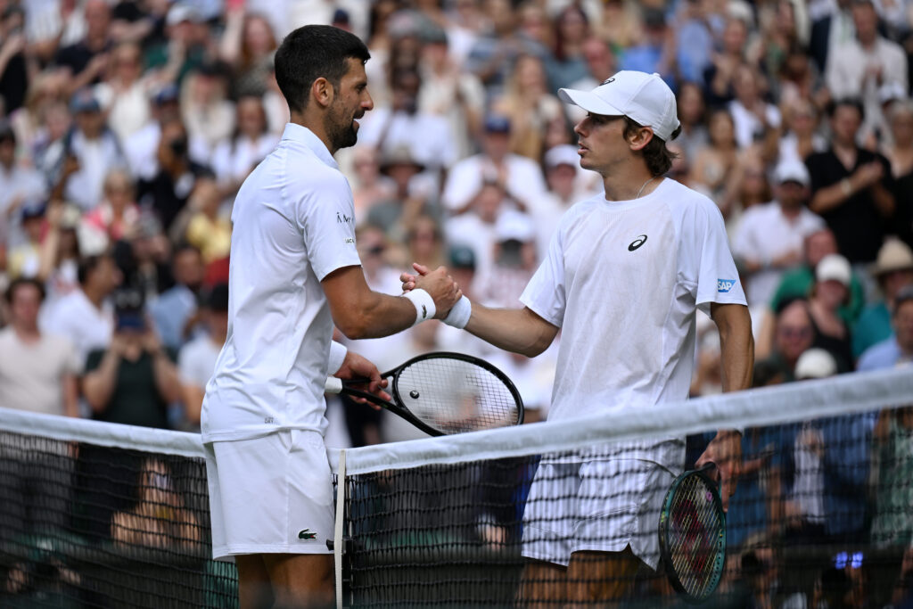 Novak Djokovic and Alex de Minaur at the net following their fourth-round clash at Wimbledon.