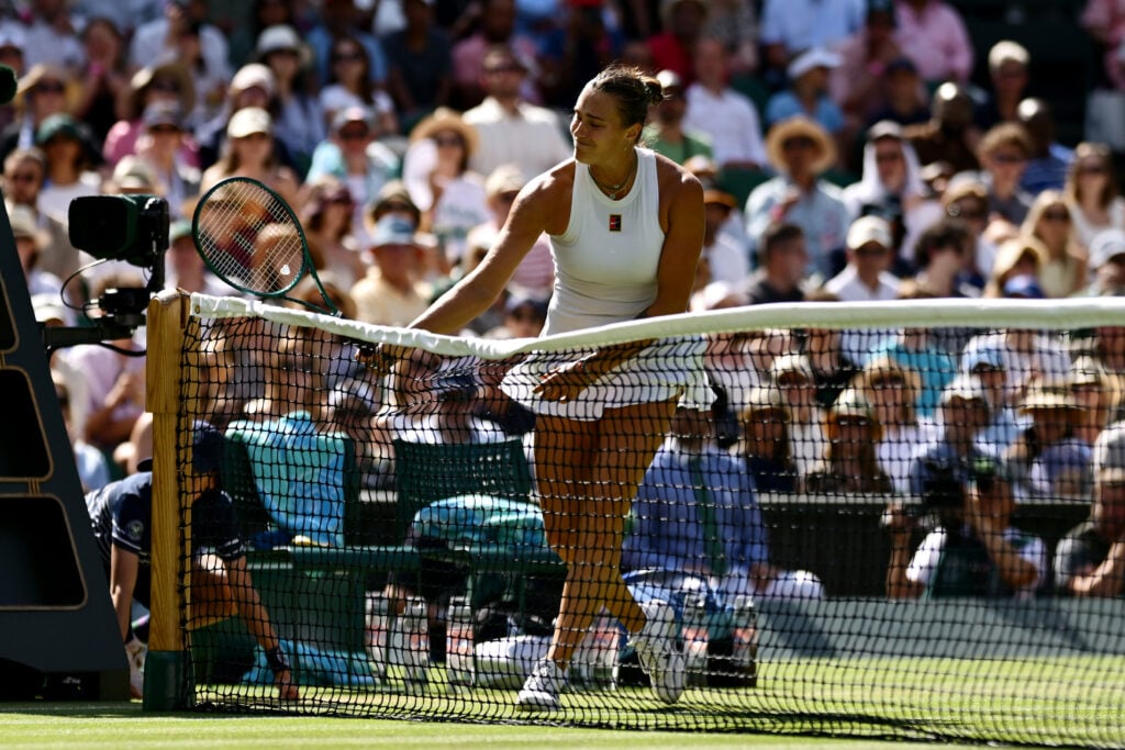 Aryna Sabalenka hits the net in frustration