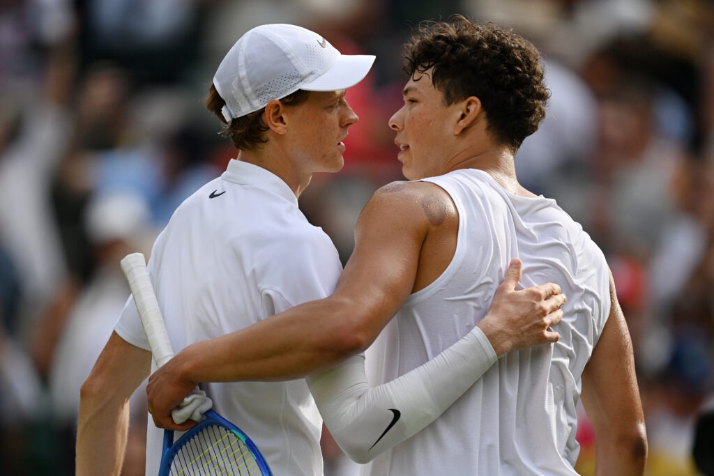 Jannik Sinner and Ben Shelton embrace after their match at Wimbledon in 2025