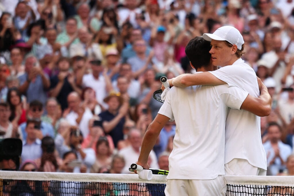 Jannik Sinner and Carlos Alcaraz embrace after the 2025 Wimbledon final