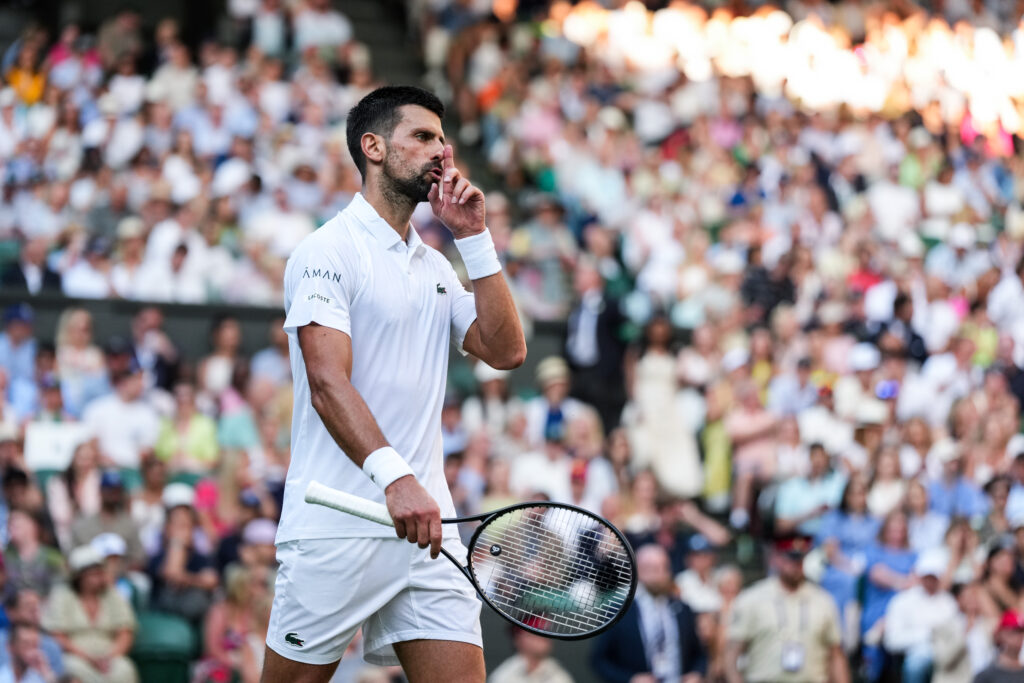 Novak Djokovic reacts in his match vs Flavio Cobolli at Wimbledon in 2025.