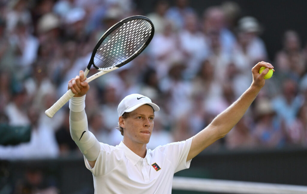 Jannik Sinner celebrates at Wimbledon after defeating Novak Djokovic.
