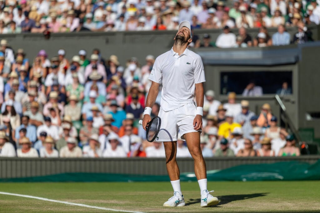 Novak Djokovic looks dejected during his semifinal defeat to Jannik Sinner at Wimbledon in 2025