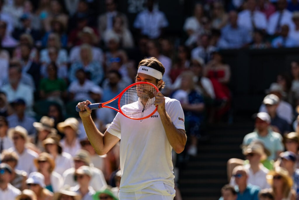 Taylor Fritz reacts during his match with Carlos Alcaraz at Wimbledon in 2025.