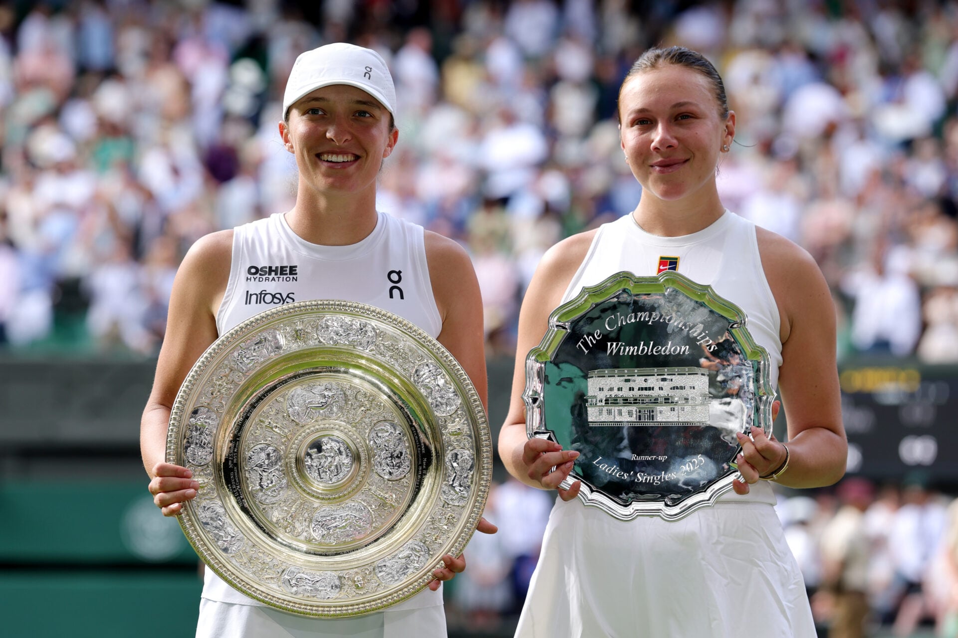 Iga Swiatek and Amanda Anisimova pose with their trophies after the 2025 Wimbledon final