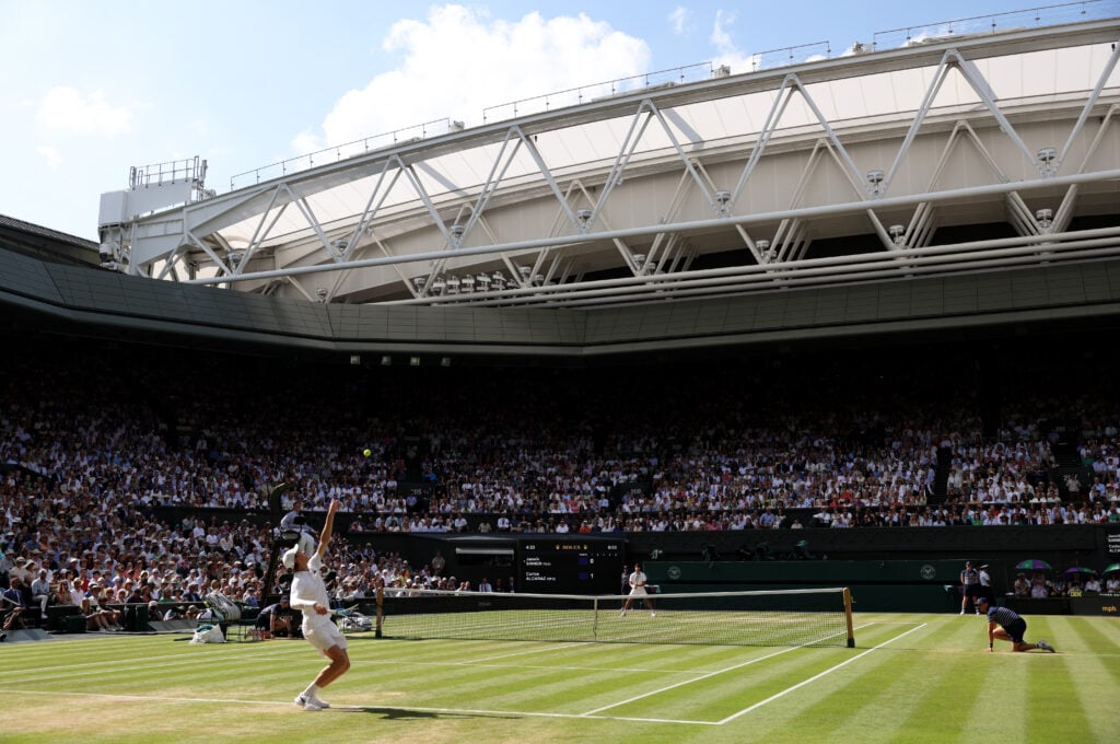 A general view over Centre Court as Jannik Sinner of Italy serves against Carlos Alcaraz of Spain during the Gentleman's Singles Final on day fourteen of The Championships Wimbledon 2025 at All England Lawn Tennis and Croquet Club.
