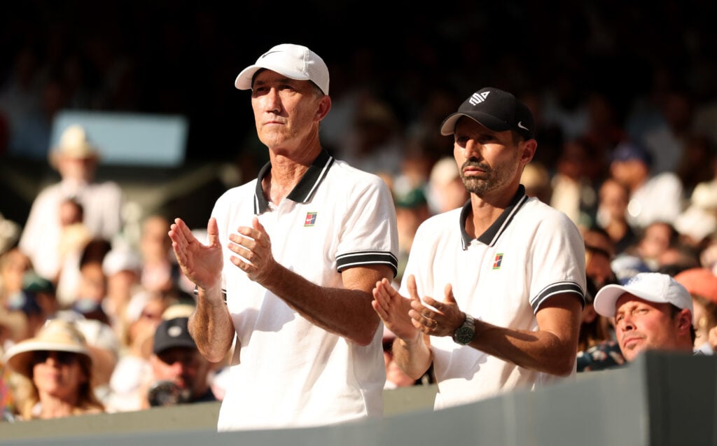 Darren Cahill and Simone Vagnozzi applaud from the player’s box in the Wimbledon 2025 final