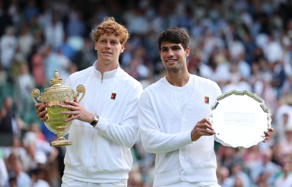 Jannik Sinner and Carlos Alcaraz pose with their trophies after the 2025 Wimbledon final