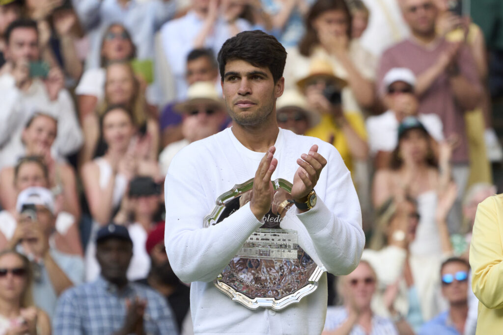 Carlos Alcaraz of Spain holds the Gentlemens' Singles Plate after losing to Jannik Sinner of Italy in the Gentlemens' singles final on Centre Court on day fourteen of The Championships Wimbledon 2025 at All England Lawn Tennis and Croquet Club.