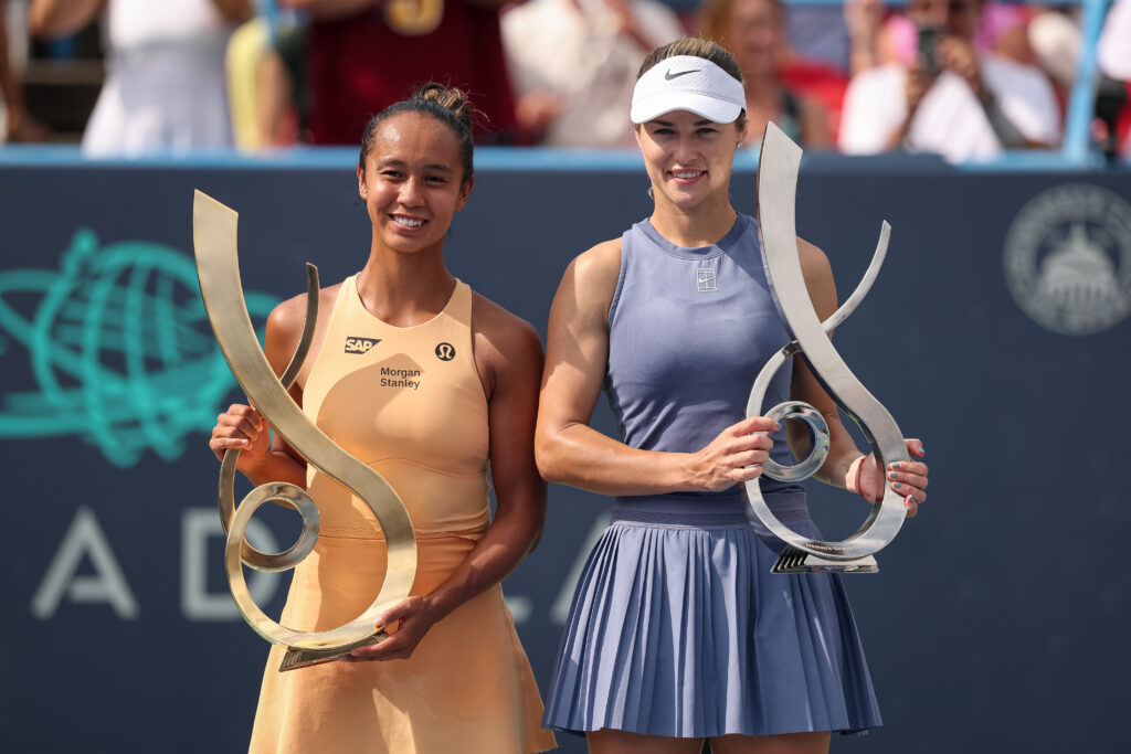 Leylah Fernandez of Canada poses with the championship trophy and Anna Kalinskaya poses with the finalist trophy after a women's singles championship match against on the final day of the Mubadala Citi DC Open 2025 at William H.G. FitzGerald Tennis Center.