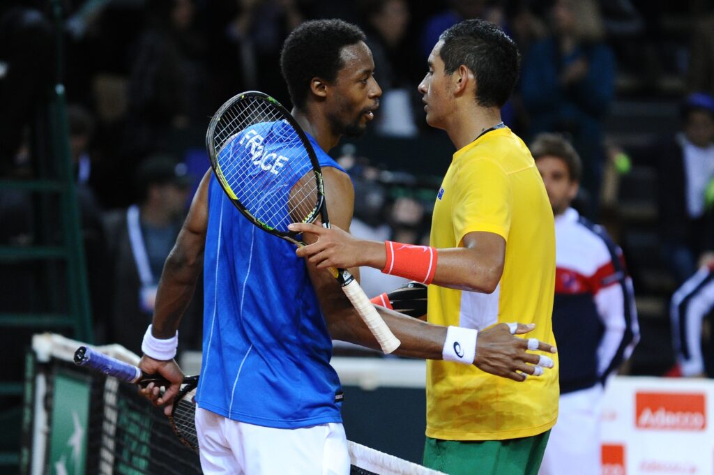 Gael Monfils shakes hands with Australia's Nick Kyrgios after their Davis Cup first round tennis match France vs Australia at The Vendespace in Mouilleron-le-Captif.