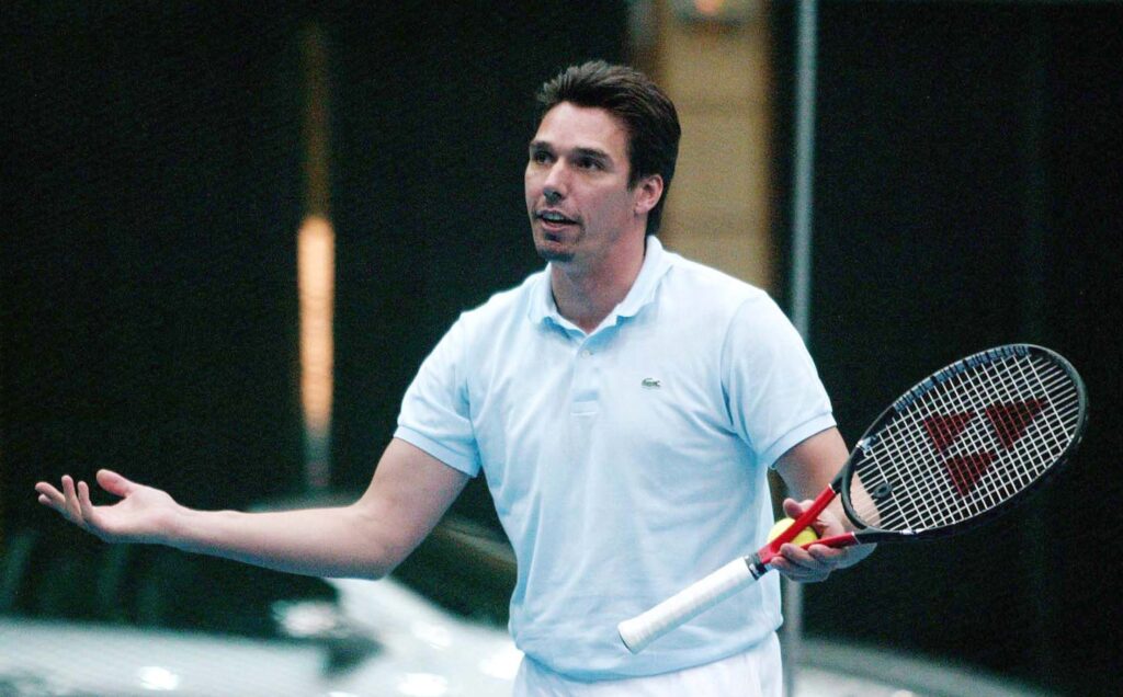 German tennis player Michael Stich waving his hands in 2004.