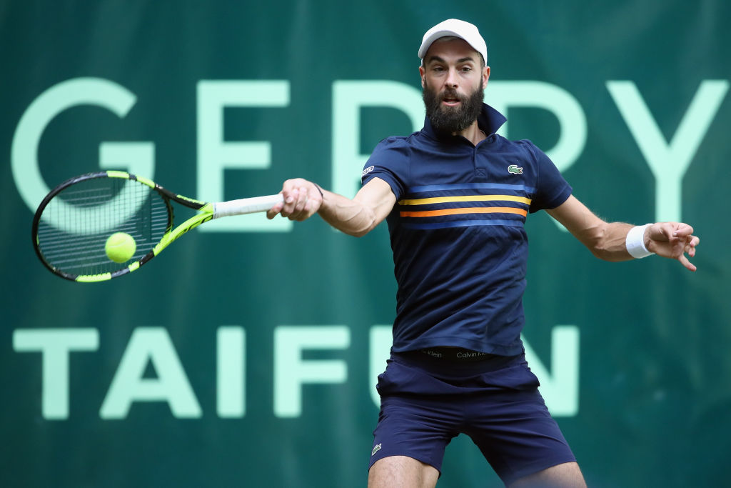 Benoit Paire of France plays forehand to Roger Federer of Switzerland during their round of 16 match on day 4 of the Gerry Weber Open at Gerry Weber Stadium.