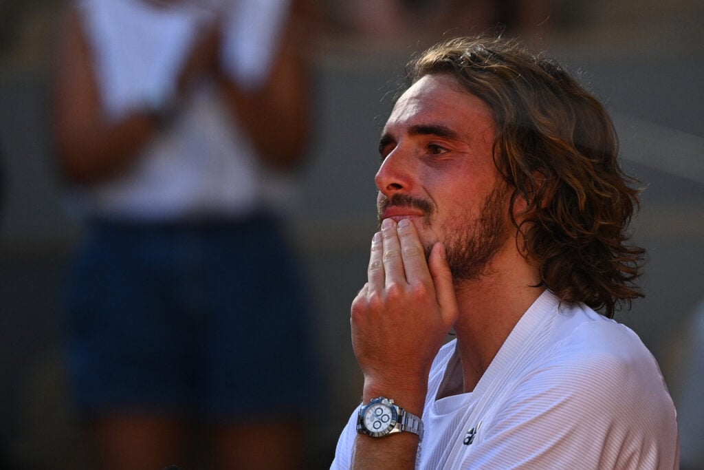 Stefanos Tsitsipas cries after winning against Germany's Alexander Zverev during their men's singles semi-final tennis match on Day 13 of The Roland Garros 2021 French Open tennis tournament in Paris.