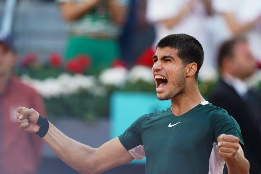 Carlos Alcaraz of Spain celebrates his win over Novak Djokovic at the Madrid Open in 2022.