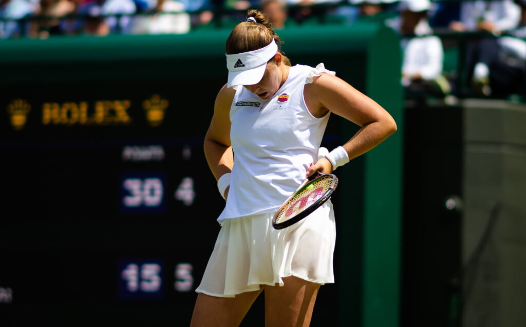 Jelena Ostapenko of Latvia in action against Tatjana Maria of Germany in her fourth round match during Day Seven of The Championships Wimbledon 2022