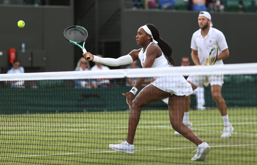 Coco Gauff hits a volley in mixed doubles at The Championships - Wimbledon 2022