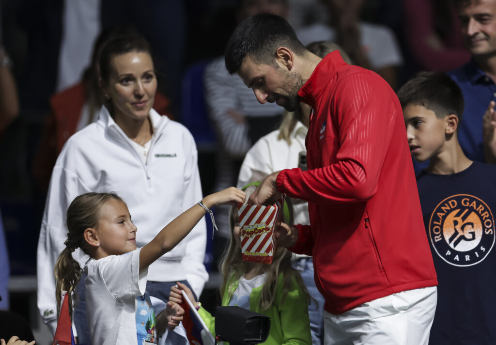 Novak Djokovic speaks with his daughter and wife at the Davis Cup World Group I: Serbia v Greece