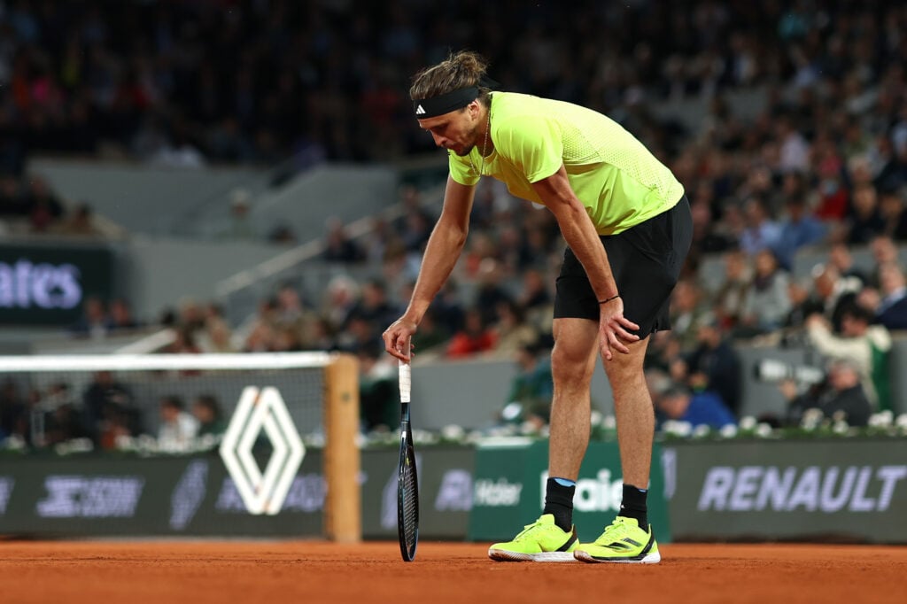 Alexander Zverev bends over, looking dejected