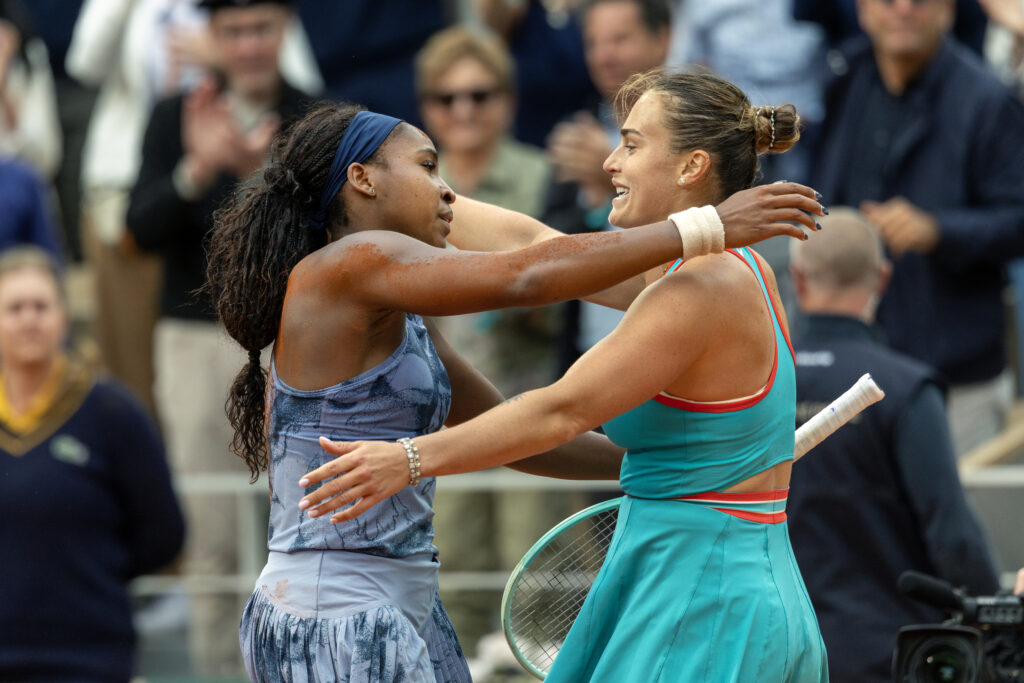 Aryna Sabalenka and Coco Gauff hug at the net