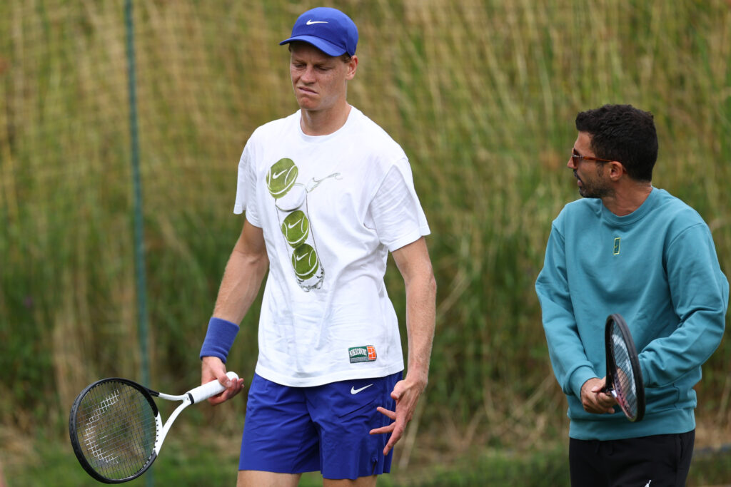 Jannik Sinner in conversation with Simone Vagnozzi at Wimbledon in 2025