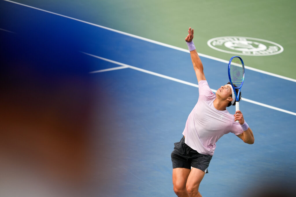 Ben Shelton serves against Flavio Cobolli at the National Bank Open 2025
