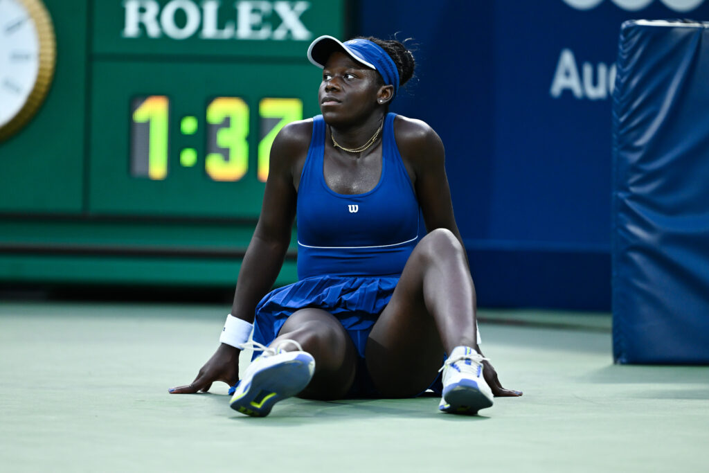 Victoria Mboko of Canada falls to the court in the third set against Elena Rybakina of Kazakhstan during their semifinal singles women's match on Day Eleven of the WTA 1000 National Bank Open at IGA Stadium.