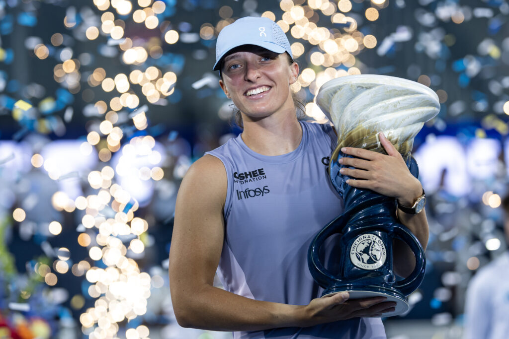 Iga Swiatek of Poland poses with the winner's trophy after beating Jasmine Paolini of Italy in the finals of the women's singles at the Lindner Family Tennis Center.