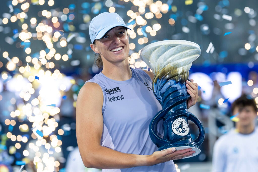 Iga Swiatek of Poland poses with the winner's trophy after beating Jasmine Paolini of Italy in the finals of the women's singles at the Lindner Family Tennis Center.