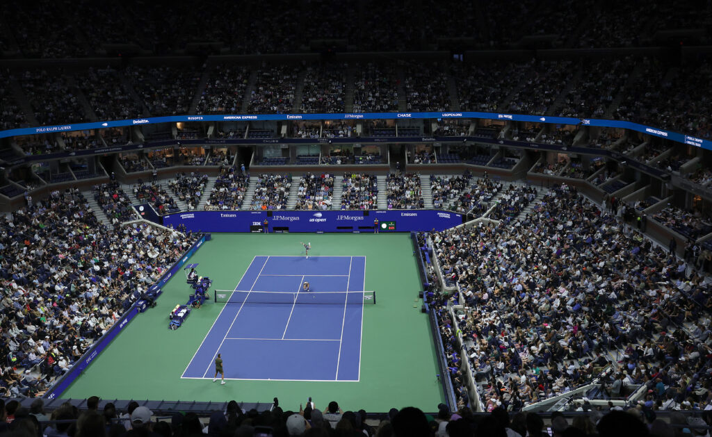 Jack Draper of Great Britain serves the ball teammate Jessica Pegula of the United States is in position in the match against Iga Swiatek of Poland and Casper Ruud of Norway during the Mixed Doubles Semifinal at USTA Billie Jean King National Tennis Center.