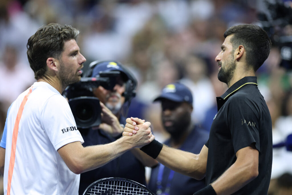 Novak Djokovic shakes hands with celebrates Britain's Cameron Norrie after winning their men's singles third round match on day six of the US Open tennis tournament at the USTA Billie Jean King National Tennis Center in New York City.