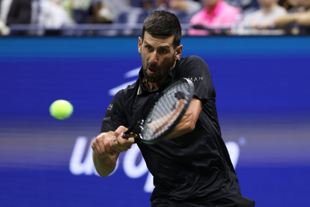 Novak Djokovic playing a backhand at the US Open.