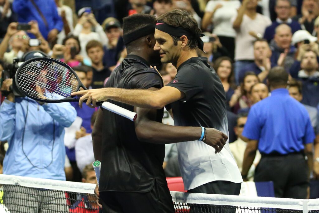 Frances Tiafoe of United States and Roger Federer (R) of Switzerland congratulate each other after their Men's Singles tennis match within 2017 US Open Tennis Championships at Arthur Ashe Stadium in New York.