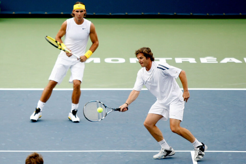 Francisco Roig of Spain returns a shot to Novak Djokovic and Dusan Vemic of Serbia while playing with Rafael Nadal of Spain during the Rogers Cup at Uniprix Stadium.