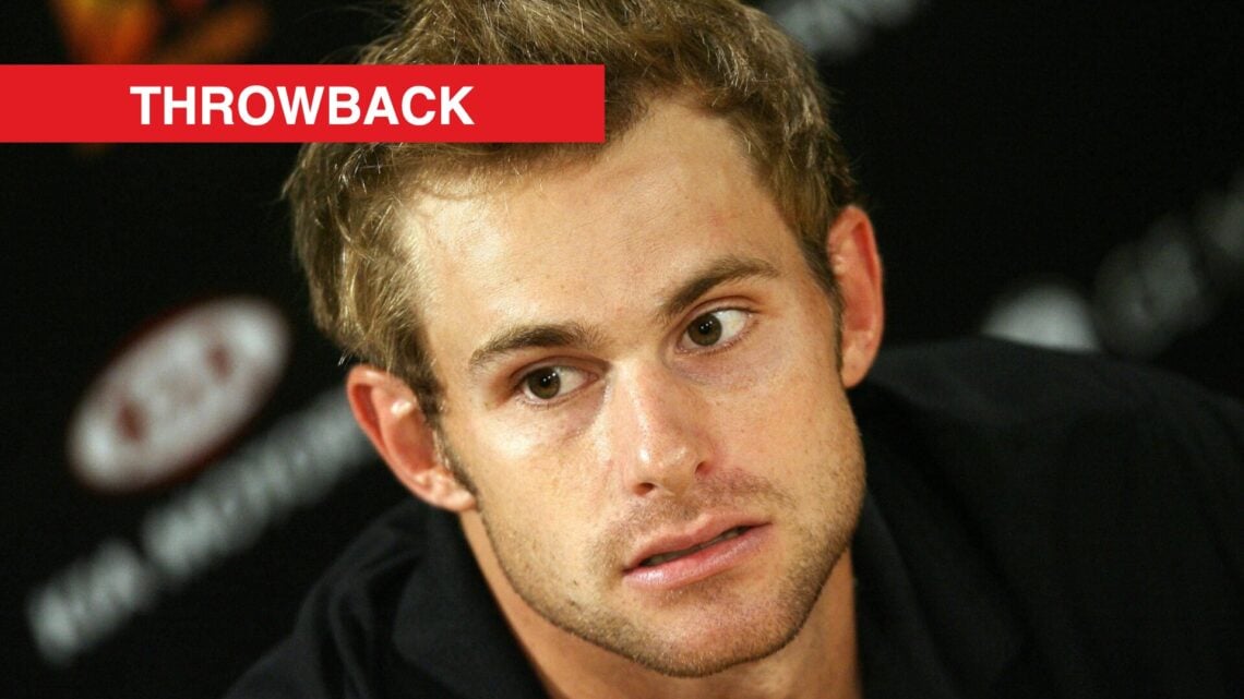Andy Roddick at an Australian Open press conference, with a throwback banner.
