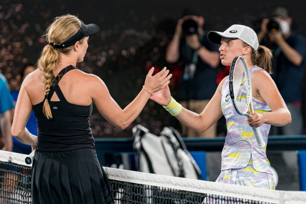 Danielle Collins and Iga Swiatek shake hands at the net after their match at the 2022 Australian Open