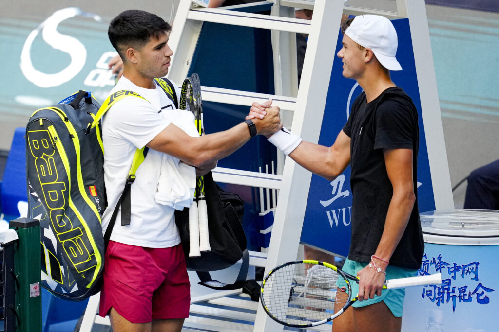 Carlos Alcaraz of Spain and Holger Rune of Denmark shake hands during a practice session ahead of The 2023 China Open on day two of the 2023 China Open at National Tennis Center.