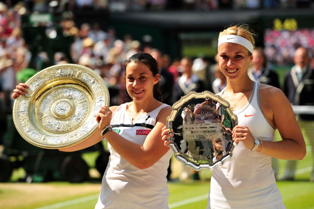 Marion Bartoli poses with the winner's Venus Rosewater Dish and Germany's Sabine Lisicki poses with the runners up trophy after end of their women's singles final match on day twelve of the 2013 Wimbledon Championships tennis tournament at the All England Club in Wimbledon.