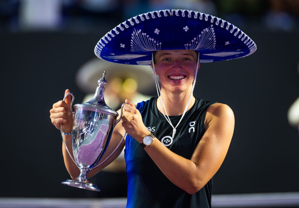 Iga Swiatek celebrates with the WTA Finals title in 2023