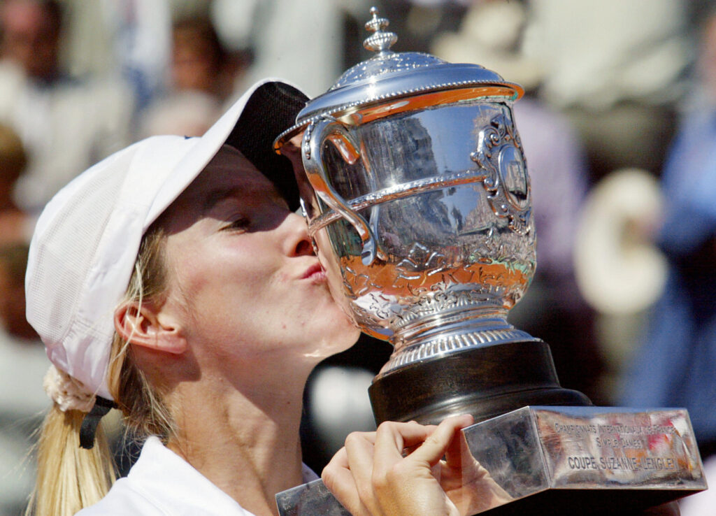 Justine Henin-Hardenne kisses her trophy following her Roland Garros French Tennis Open women singles final match against her compatriot Kim Clijsters.