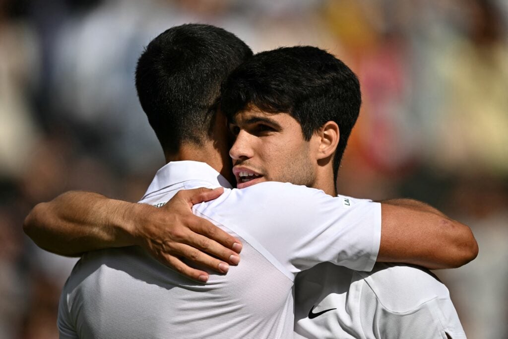 Novak Djokovic and Carlos Alcaraz embrace after the 2024 Wimbledon final.