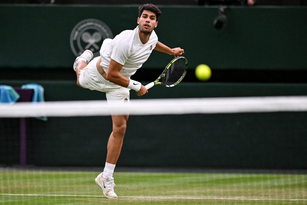 Carlos Alcaraz serving at Wimbledon.