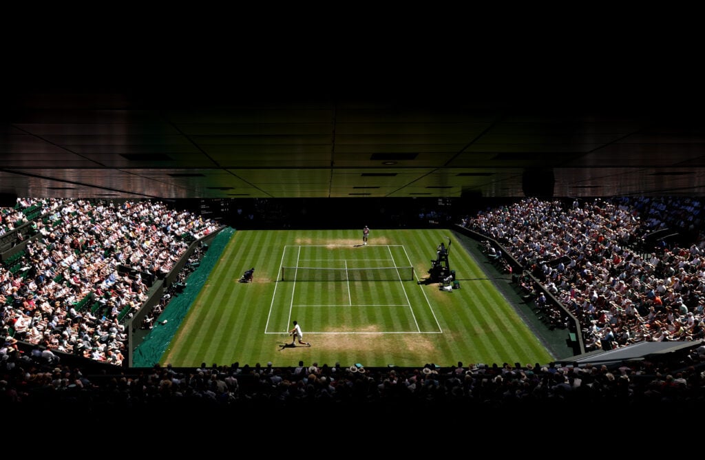 A general view over Centre Court as Carlos Alcaraz of Spain plays a backhand against Taylor Fritz of United States during the Gentlemen's Singles semi-final match on day twelve of The Championships Wimbledon 2025 at All England Lawn Tennis and Croquet Club.
