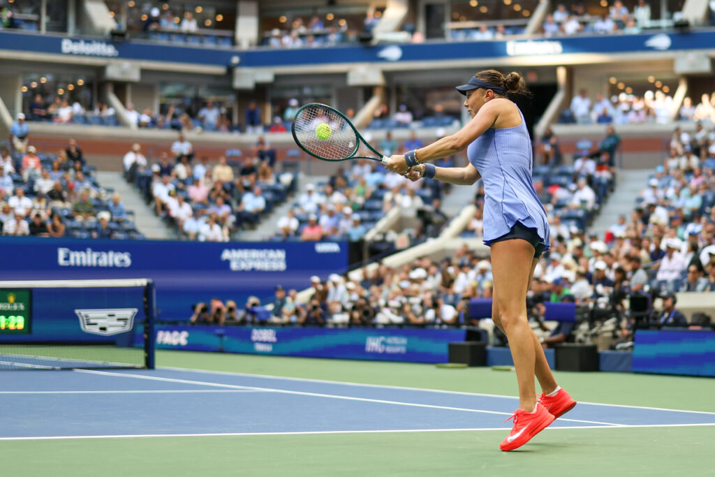 Amanda Anisimova hits a backhand to Iga Swiatek at the 2025 US Open
