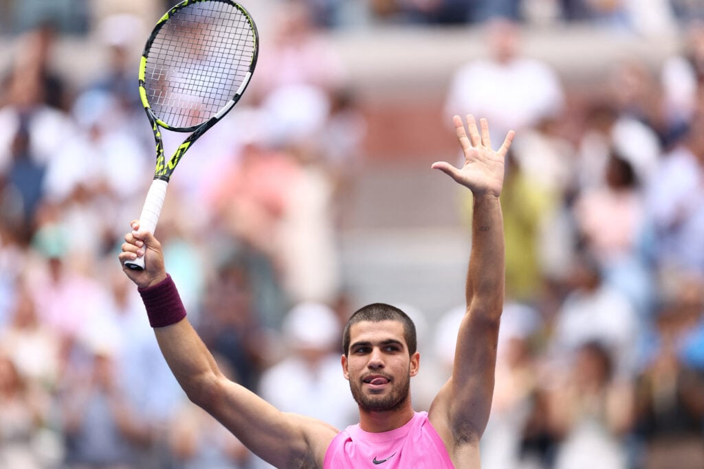 Carlos Alcaraz celebrates after beating Novak Djokovic.