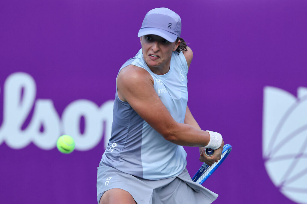 Iga Swiatek hits a return at the 2025 Korea Open