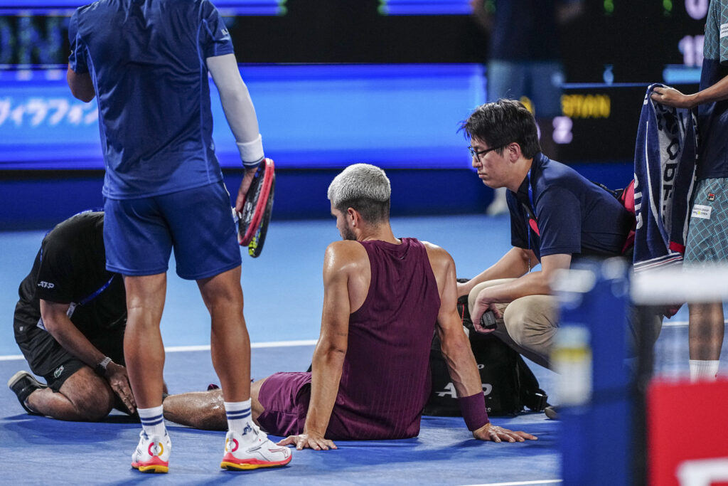 Carlos Alcaraz gets medical attention during his men's singles round-of-32 match against Argentina's Sebastian Baez at the ATP Japan Open tennis tournament in Tokyo.
