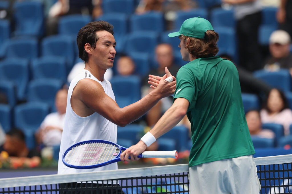 Yunchaokete Bu and Alex de Minaur shake hands at the China Open.